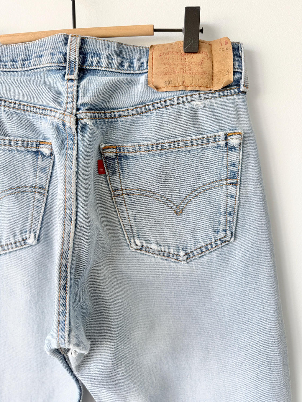 W31 L31 vintage Levis 501 30-31” measured waist light blue very distressed faded denim made in USA 90s