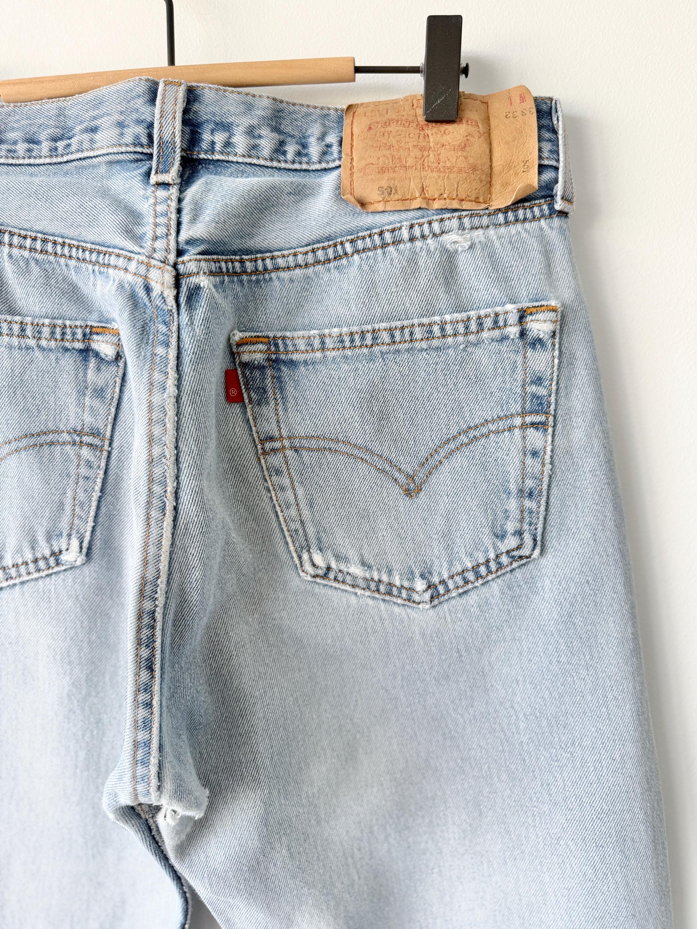 W31 L31 vintage Levis 501 30-31” measured waist light blue very distressed faded denim made in USA 90s