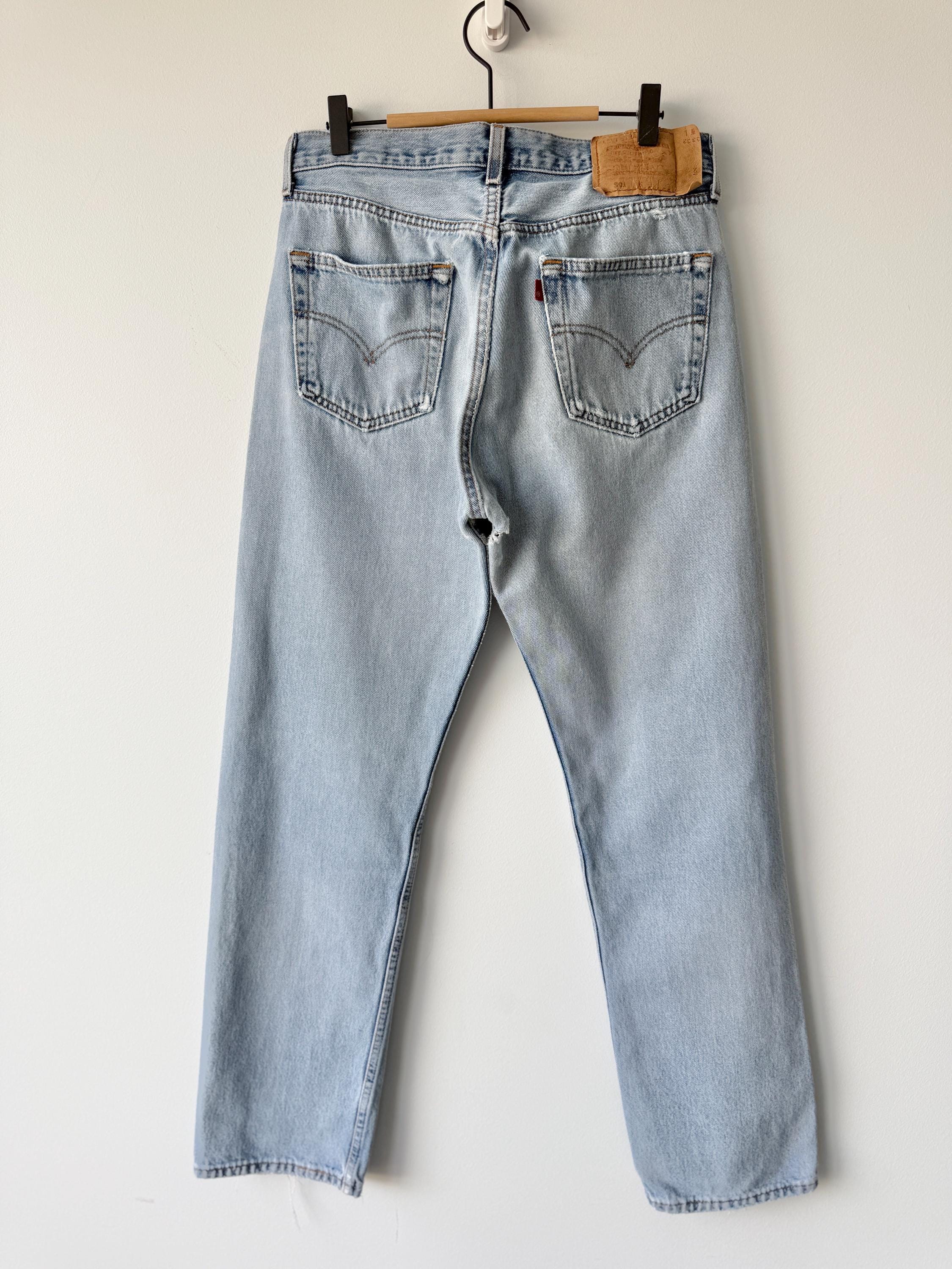 W31 L31 vintage Levis 501 30-31” measured waist light blue very distressed faded denim made in USA 90s